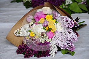 Flower wedding arrangement with ranunculus, pion, roses photo