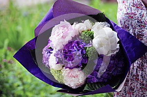 Flower wedding arrangement with ranunculus, pion, roses