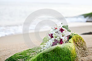 Flower wedding bouquet on tropical beach