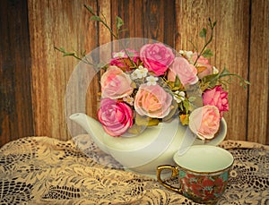 Flower in a white tea pot and vintage , cozy home rustic decor,