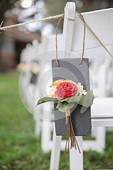 Flower on white wedding chairs