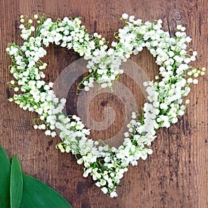 Flower wreath on rustic wooden background