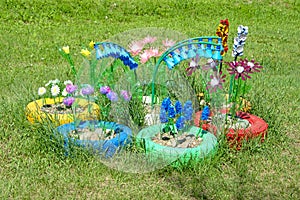 Flowerbed with flowers made from old plastic bottles