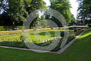 Flowerbeds in park with fountain in background. photo