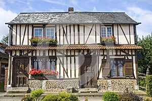 Flowered window of old house in Normandy