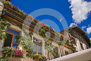 Flowering balcony in the historic center of San Candido, Italian Dolomites