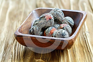 Flowering Chinese tea in a wooden bowl.