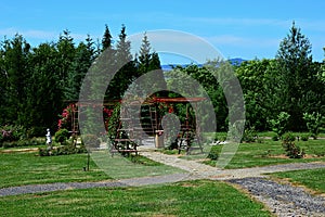 Flowering red rose decorative arches in rosarium of Arboretum Mlynany, Slovakia