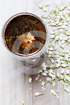 Flowering Tea and Dry Flowers on Wooden Background