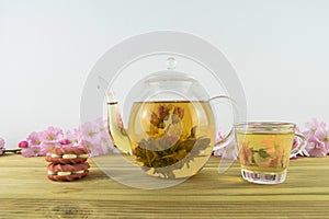 Flowering tea with strawberry pink biscuits or cookies