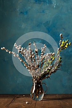 flowering willow and boxwood in a glass decanter