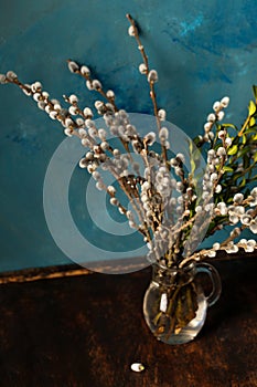 flowering willow in a glass decanter