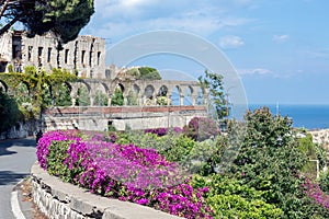 Flowers and ancient architecture in Taormina at Sicily, Italy