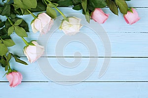 Flowers background. Bouquet of beautiful pink roses on blue wooden background.