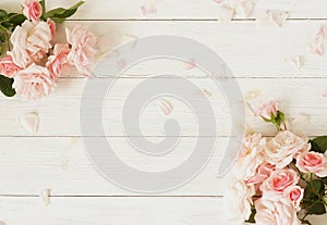 Flowers background. Bouquet of beautiful pink roses on white wooden background.