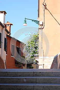 Flowers on balconies of houses in Venice.