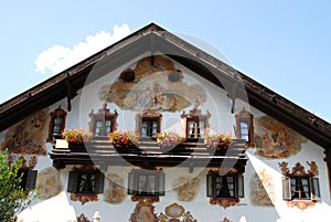 Flowers on the balcony windows and frescoes in Oberammergau in Germany