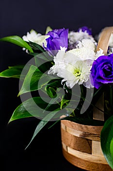 Flowers in a basket. Roses in a basket. Present. Flowers are white and purple