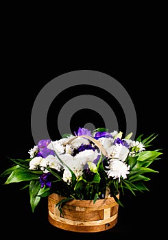 Flowers in a basket. Roses in a basket. Present. Flowers are white and purple