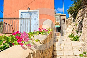 Flowers and blue door of a Greek house in Assos village, Kefalonia island, Greece