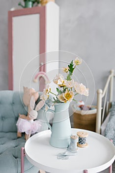 Flowers in a blue vase in the interior of a modern children`s room. Bedroom Decor for children