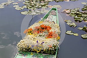 Flowers on boat at floating market in morning on Dal Lake in Srinagar, India