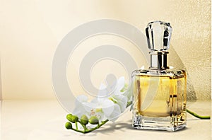 Perfume bottle and flowers on background