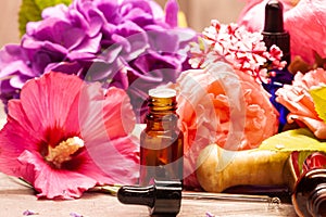 Flowers and bottles of essential oils for aromatherapy