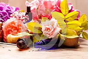 Flowers and bottles of essential oils for aromatherapy