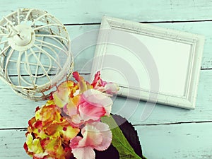Flowers bouquet and blank photo frame with copy space background