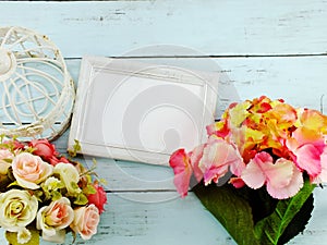 Flowers bouquet and blank photo frame with copy space background