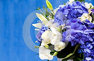 Flowers bouquet of blue hidrangea and white eustomas.