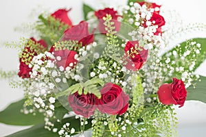 Flowers bouquet form up flat lay red roses on white background