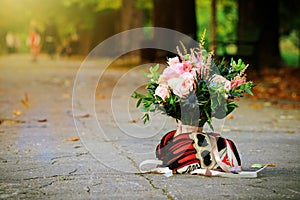 Flowers bouquet held by motorbike gloves