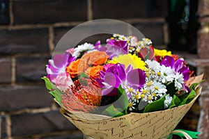 Flowers bouquet with Leucospermum, roses and orchids
