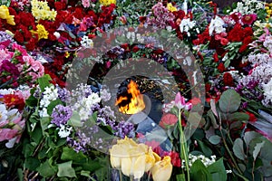 Flowers brought by people to the burning `Eternal Fire` on Victory Day over fascism, May 9