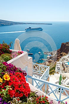 Flowers, buildings and cruise ship in Oia, Santorini photo