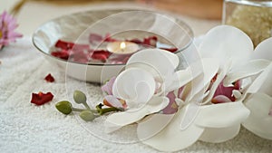 Flowers, candle and rose petals. Scenery in the spa