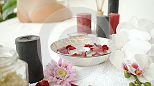 Flowers, candles and rose petals. Scenery in the spa. Relax