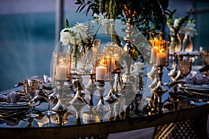 Flowers. Candles. Sunset. Wedding decoration. Floral arrangements