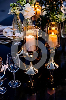 Flowers. Candles. Sunset. Wedding decoration. Floral arrangements