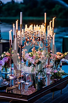 Flowers. Candles. Sunset. Wedding decoration. Floral arrangements