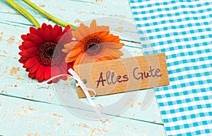 Flowers with card and german text, Alles Gute, means best wishes