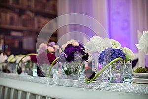 Flowers closeup at wedding reception table in purple