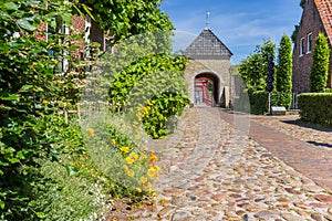 Flowers and cobblestones in front of the entrance gate of Bourtange