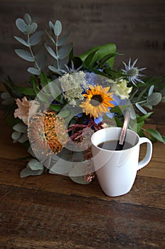 Flowers with coffee cup photo