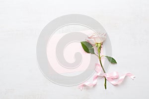 Flowers composition. Frame made of pink rose on gray background. Flat lay, top view, copy space