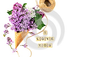 Flowers composition. Lilac in waffle cone. Flat lay, top view, copy space. Concept of proposal, love and tenderness.