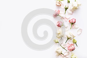 Flowers composition. Rose flowers on white background. Flat lay, top view, copy space.  Border frame