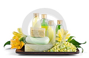 Flowers with cosmetics bottles of liquids on